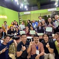 Energetic group of bootcamp attendees with thumbs up